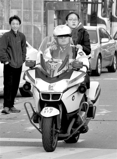 7日，首爾，警察將一名考生送抵考場(chǎng)。新華社發(fā)