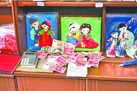 　　2012年6月21日，在朝鮮羅先特別市的一家商店里，柜臺(tái)上散落著一些人民幣。在朝鮮，人民幣比本國(guó)