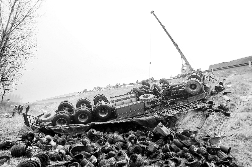 　一輛貨車沖開護(hù)欄翻下高速，輪胎散落一旁