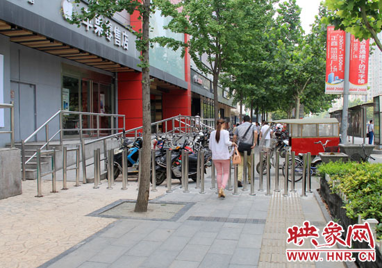 圖中道路左側(cè)的無障礙通道被鋼管隔離,右側(cè)的盲道也被侵占。